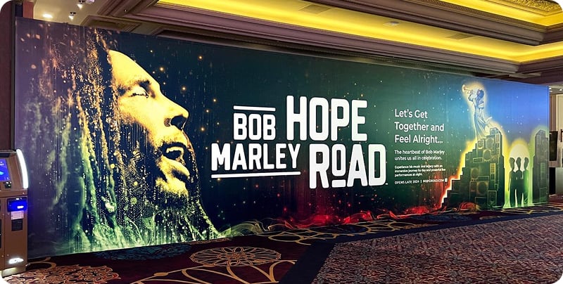 Vibrant Bob Marley themed mural in a hallway with text: Bob Marley Hope Road, promoting unity and hope.